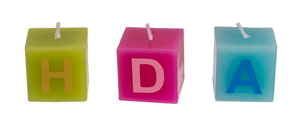 Multi coloured square candles with letters,