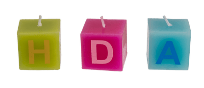 Multi coloured square candles with letters,