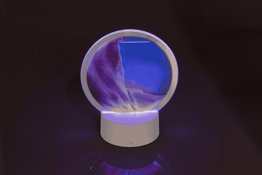 Rotating sand picture, with colour-changing LED