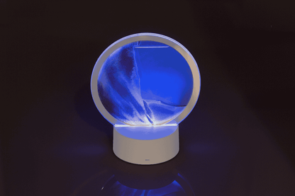 Rotating sand picture, with colour-changing LED
