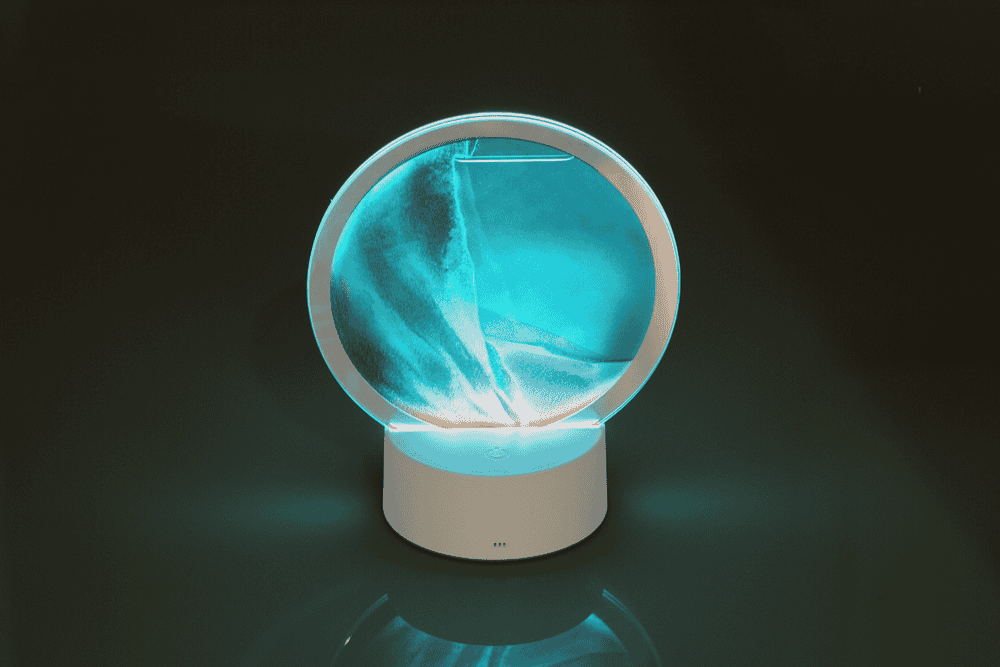 Rotating sand picture, with colour-changing LED