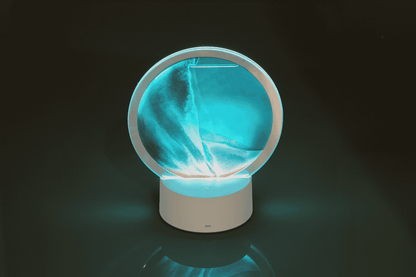 Rotating sand picture, with colour-changing LED