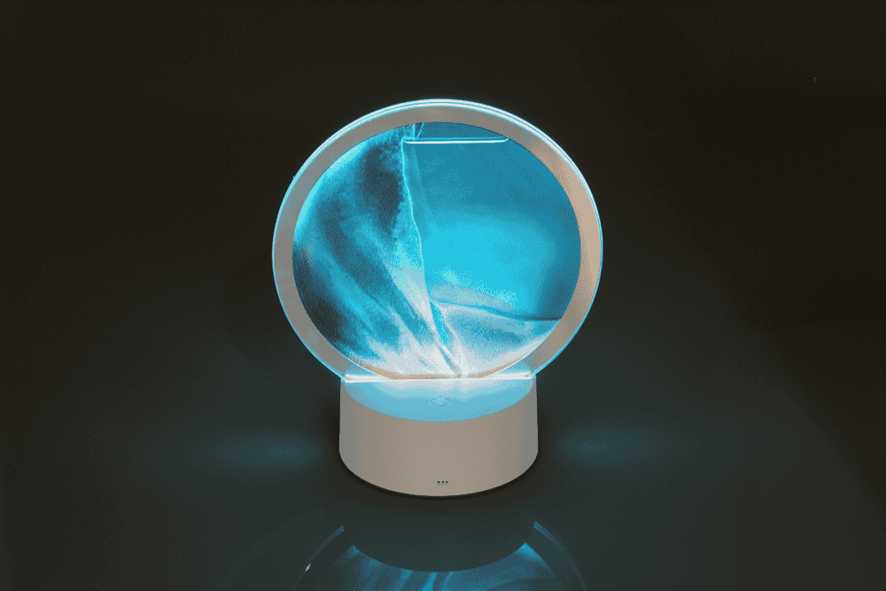 Rotating sand picture, with colour-changing LED