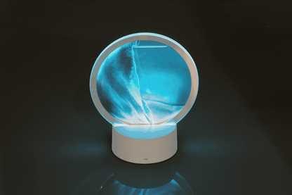 Rotating sand picture, with colour-changing LED