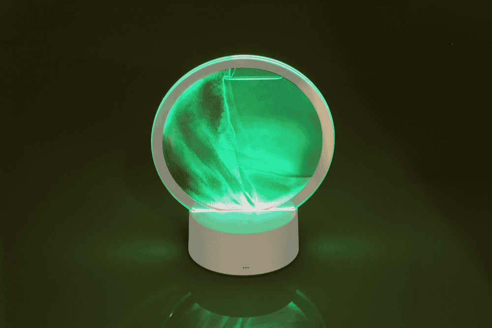 Rotating sand picture, with colour-changing LED