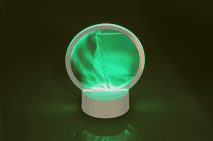 Rotating sand picture, with colour-changing LED