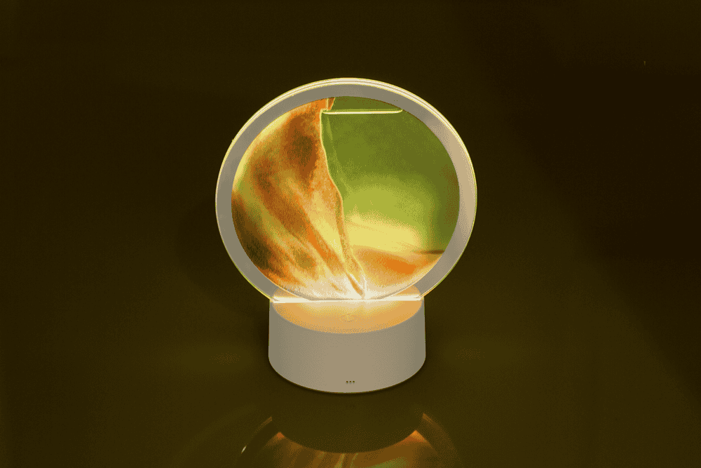 Rotating sand picture, with colour-changing LED