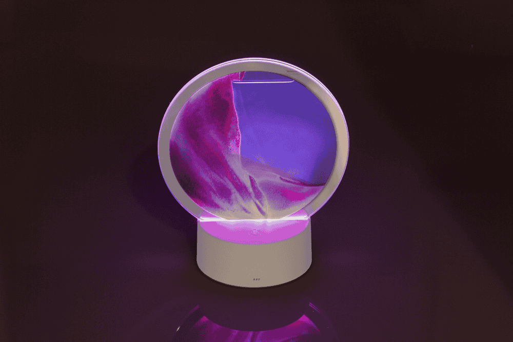 Rotating sand picture, with colour-changing LED