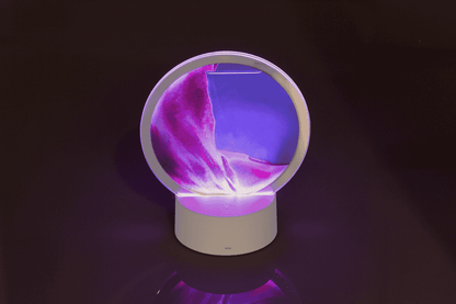 Rotating sand picture, with colour-changing LED