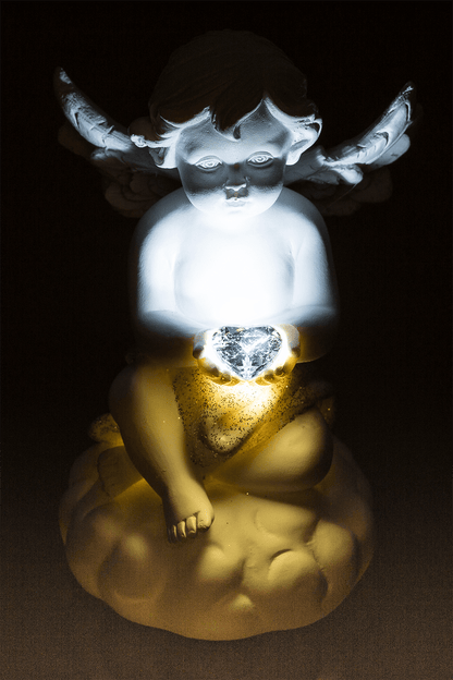 Sitting polyresin angel with white LED heart,