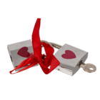 Silver coloured love lock with red heart,