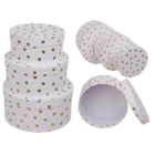 White colored round giftbox with golden dots,